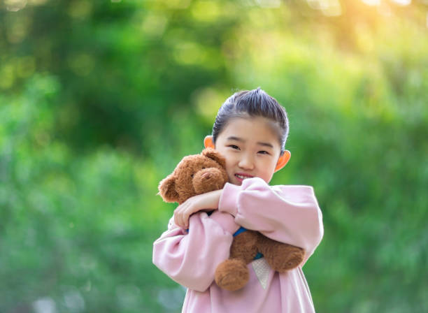 istock Girl hugging teddy bear 1318836005