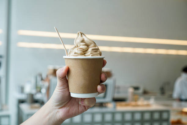 istock Hand holding a coffee soft serve ice cream. 1318837664