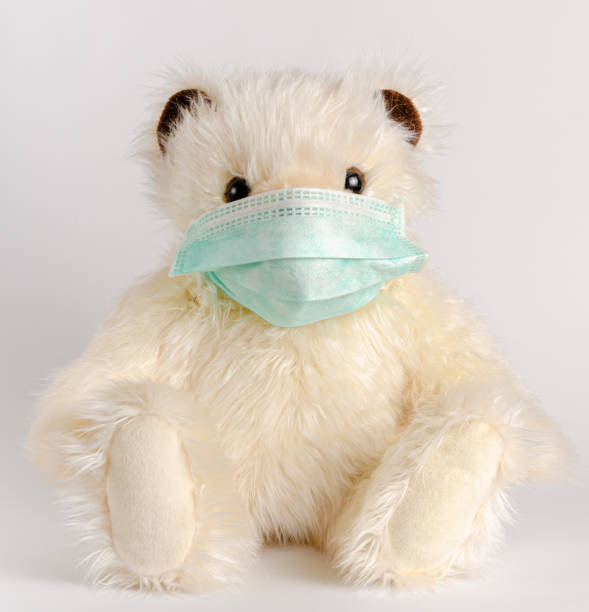 istock Teddy bear sitting in protective medical mask. 1318837804