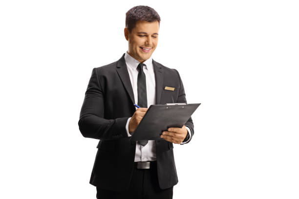 istock Male receptionist writing a document on a clipboard 1318837887