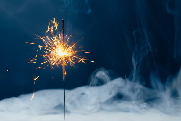 istock fire sparkler in dense smoke, abstract Christmas firework background 1318837964