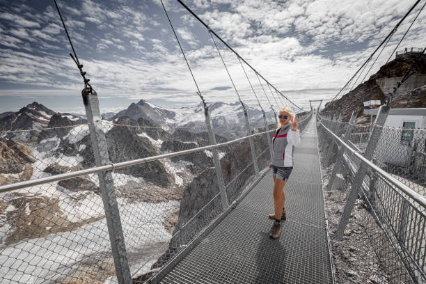 istock Woman on Titlis mount suspension bridge 1318838103