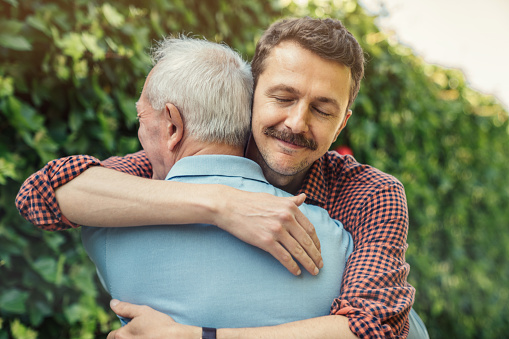 Man embracing father at birthday party