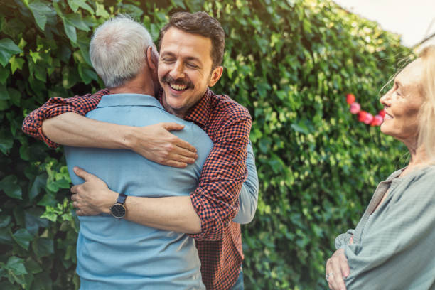 istock Man embracing father at birthday party 1318839069
