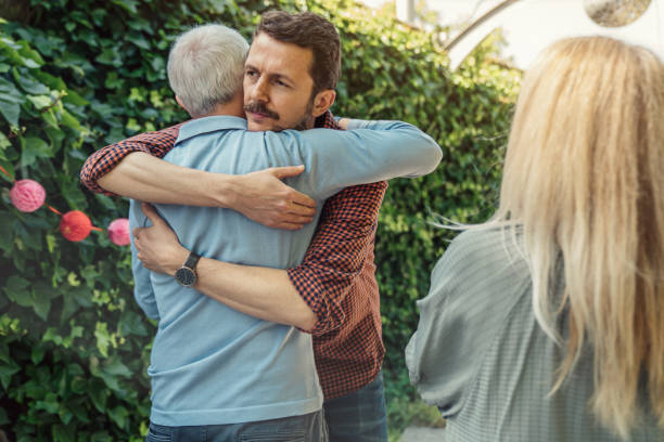 istock Man embracing father at birthday party 1318839071