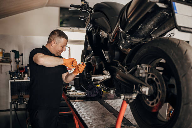 istock Male mechanic repairing motorcycle 1318839924
