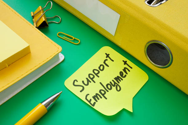 istock Support employment memo near yellow folder and notepad. 1318841243