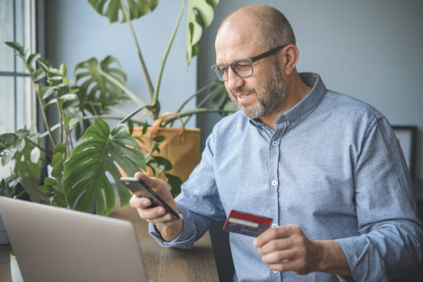 istock mature adult man working from home office ( with laptop,home shoping) 1318842104