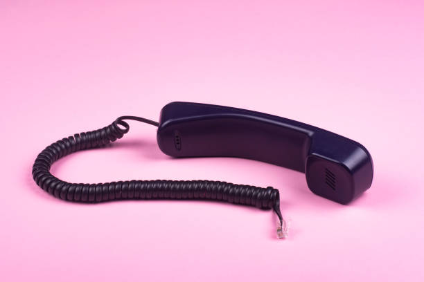 istock Telephone receiver on a pink background. 1318842144