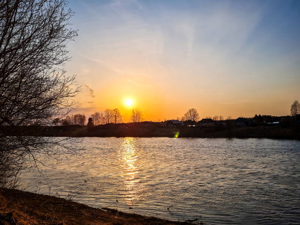 istock Sunset over the river. The sun is reflected in the water. Path of sunlight. 1318842809