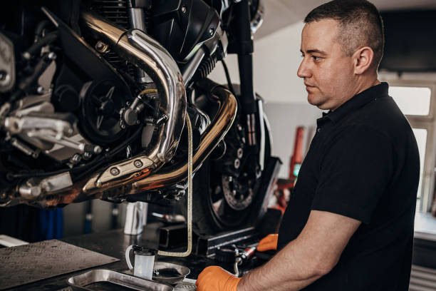 istock Male mechanic repairing motorcycle 1318844559