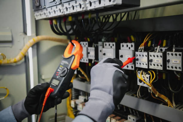 istock Electrical engineers test electrical installations and wiring on protective relays, measuring them with a multimeter. 1318845381