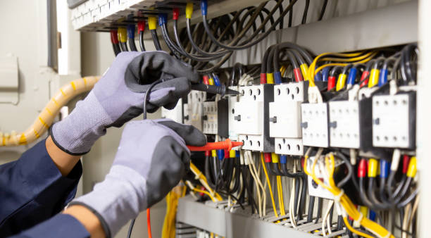 istock Electrician engineer tests electrical installations and wires on relay protection system. 1318845436