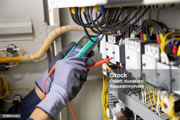 Electrician Engineer Tests Electrical Installations And Wires On Relay Protection System Stock Photo - Download Image Now