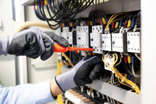 istock Electricians work to connect electric wires in the system, switchboard, electrical system in Control cabinet. 1318845466