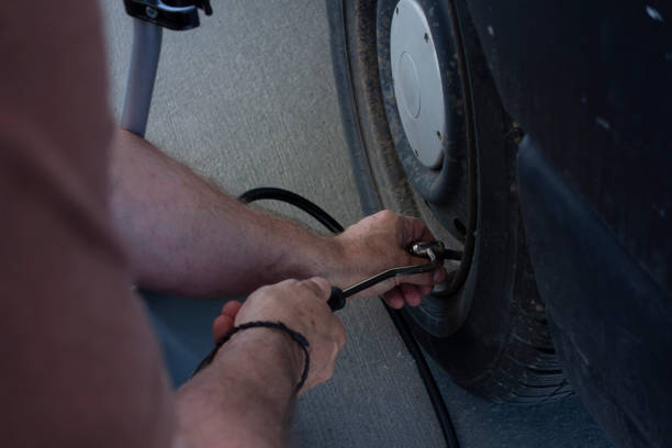 istock checking the tire pressure of a car 1318847355