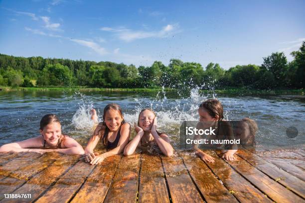 Happy Children Enjoying Summer Holidays At A Lake Stock Photo - Download Image Now - Lake, Child, Swimming
