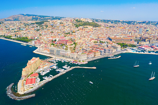 Aerial view of the colourful city of Naples and Ovo Castle on a sunny day, Italy