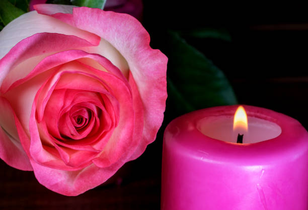 istock A candle is burning next to white-red roses 1318849035
