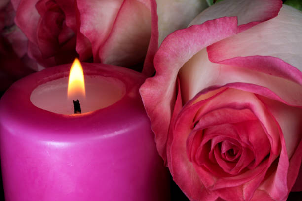 istock A candle is burning next to white-red roses 1318849039