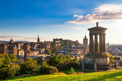 Edinburgh cityscape as viewed from the Calton Hill with the Dugald Stewart Monument in foreground in the evening sun
