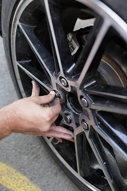 istock Man installs spare wheel 131885460