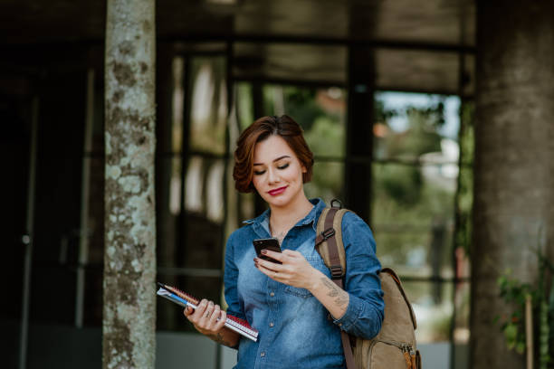 istock Young Adults lifestyle - Student using mobile phone 1318856016