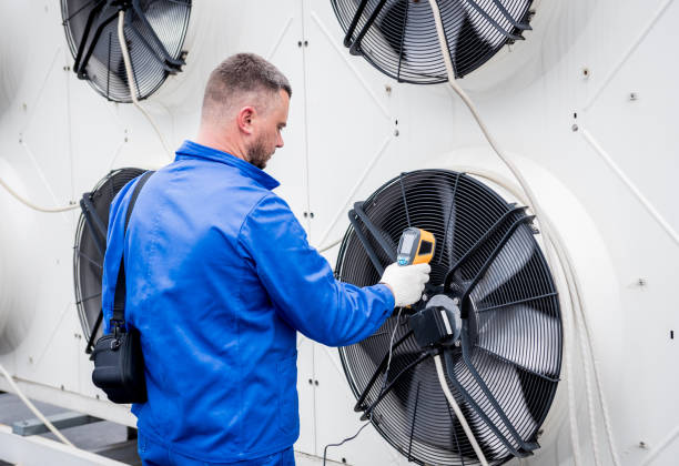 istock Technician uses a thermal imaging infrared thermometer to check the condensing unit heat exchanger. 1318857255