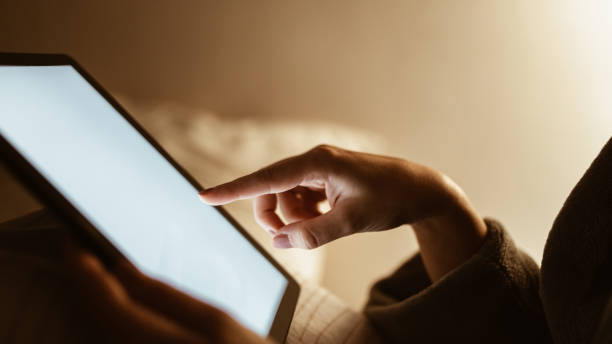 istock Young woman using tablet at night 1318857333