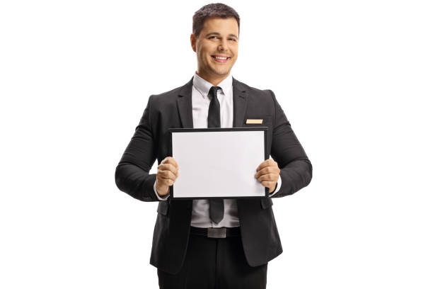 istock Man in suit and tie holding an empty board 1318858136