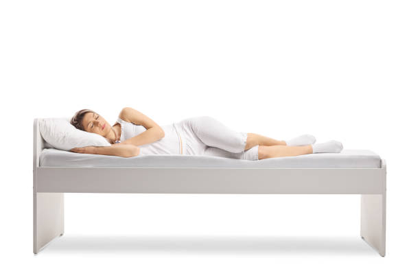 istock Woman in pajamas sleeping on a bed 1318858139
