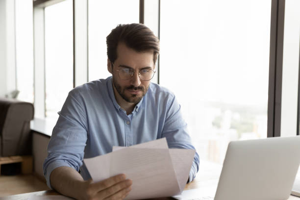 istock Young male employee work with paperwork at workplace 1318858205