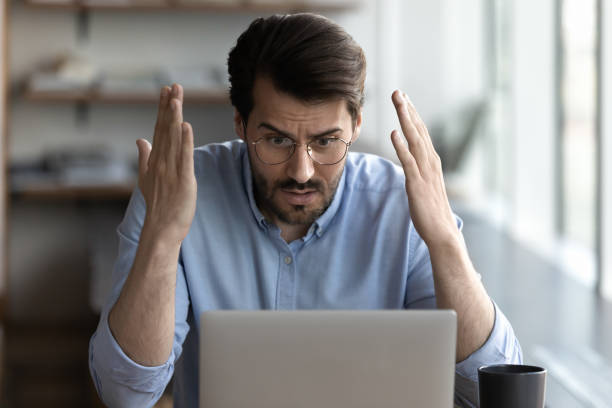 istock Unhappy man frustrated by mistake on laptop 1318858218