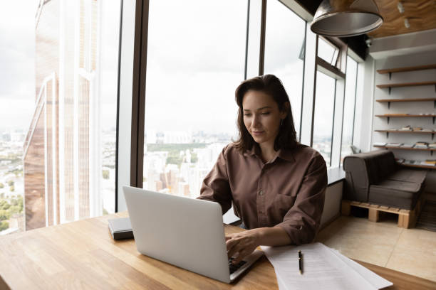 istock Successful businesswoman work on laptop in modern office 1318858271