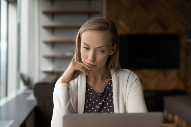 istock Pensive female employee work on computer in office 1318858291