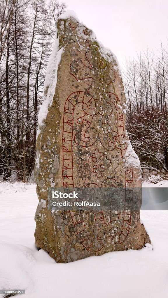 Rune stone (Risbyle 2) January photo with Rune stone with inscriptions (and cross) from the 1000's AD (Risbyle 2, Täby, Sweden) Religious Cross Stock Photo