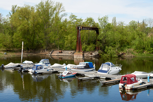 Magdeburg, Germany, May 13, 2021:  Small motor boats anchor at a jetty at the marina on the Elbe river