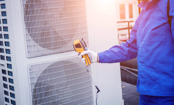istock Technician uses a thermal imaging infrared thermometer to check the condensing unit heat exchanger. 1318859023