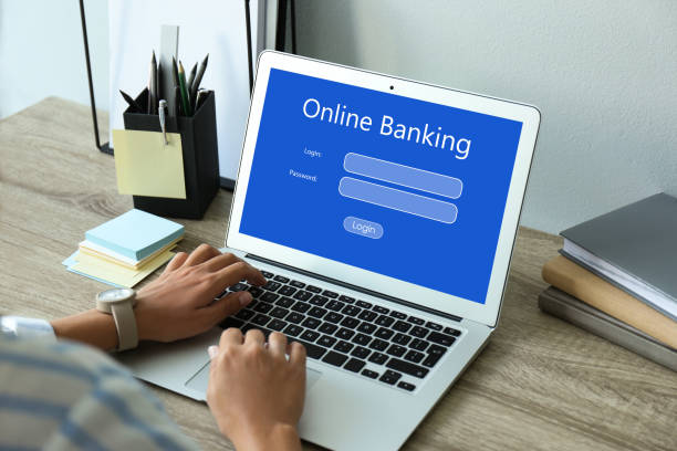 istock Woman using online banking application on laptop at table, closeup 1318859047