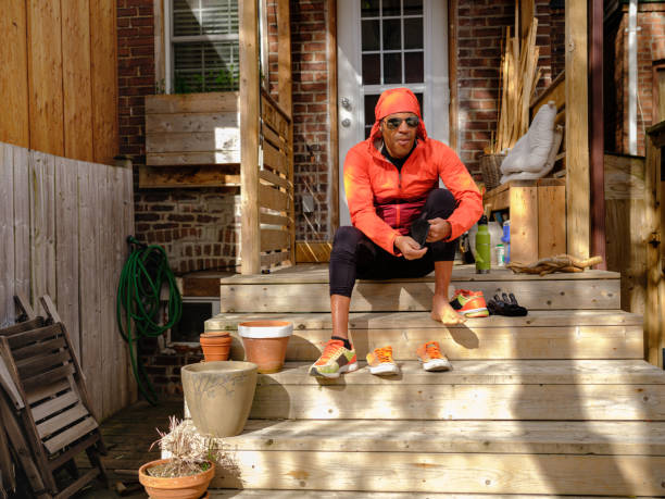 istock Black man putting on sport shoes 1318859989