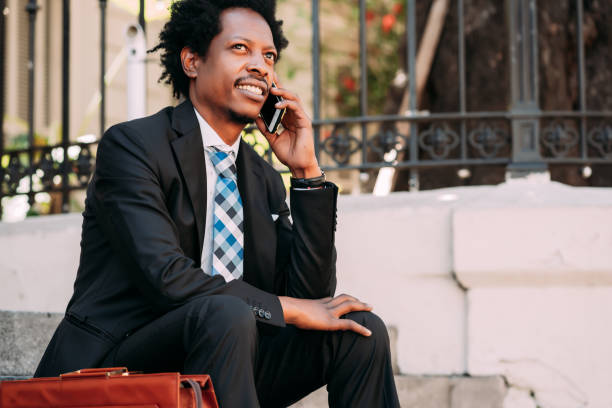 istock Businessman talking on phone outdoors. 1318860075