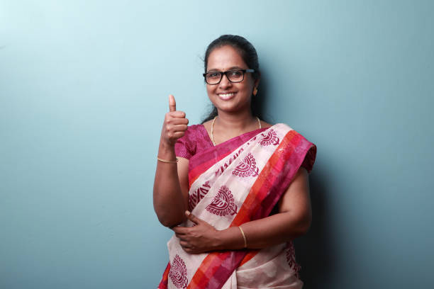 portrait of a happy woman of indian origin showing thumbs up gesture - women professor mature adult human face imagens e fotografias de stock
