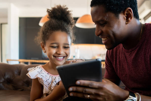 istock Father and daughter using digital tablet at home. 1318860215