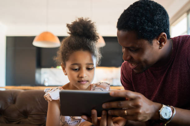 istock Father and daughter using digital tablet at home. 1318860228