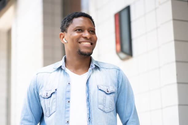 istock African american man smiling while walking outdoors. 1318860331