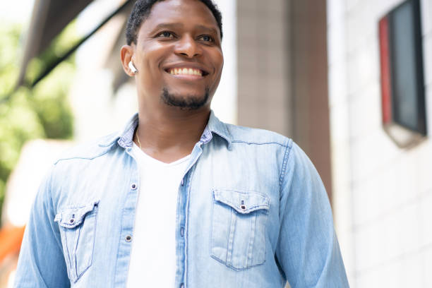 istock African american man smiling while walking outdoors. 1318860396