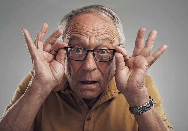 istock Studio shot of an elderly man adjusting his spectacles against a grey background 1318862055