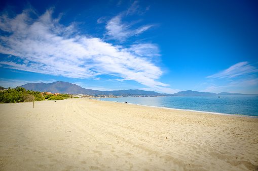 Beach beautiful sunny day sand sea ocean sky mountain Manilva, Estepona, Malaga.