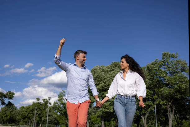 istock Young Caucasian couple flying a kite outdoors in nature 1318863152