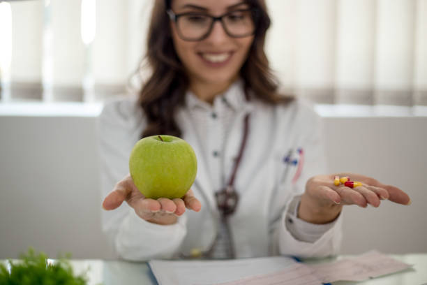 istock Doctor girl with green apple 1318863387